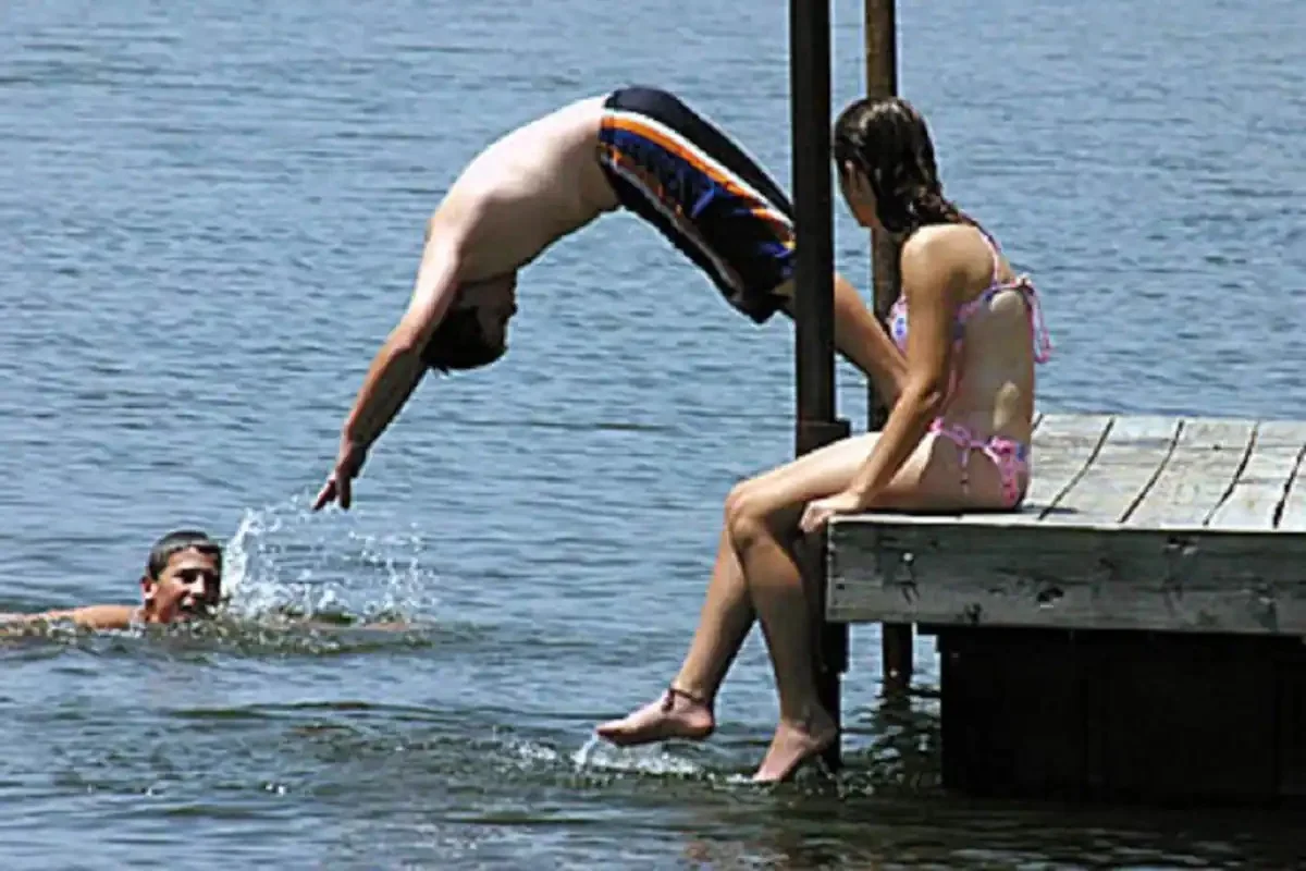 teenager-diving-from-dock